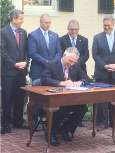 Governor McAuliffe singing clean energy bills